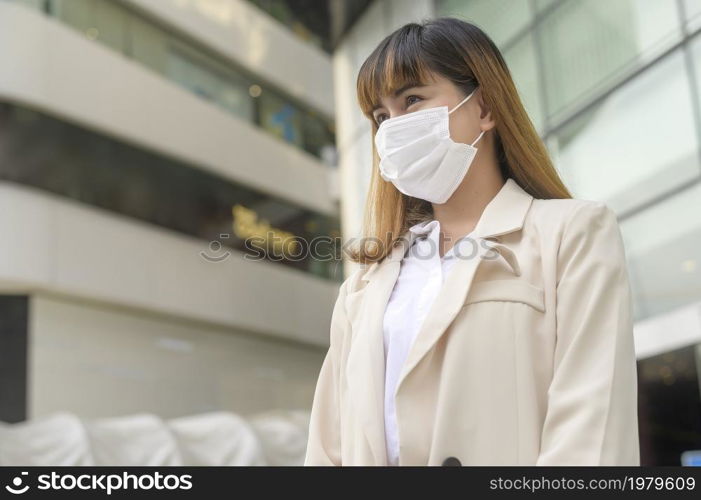 A Portrait of young beautiful Business Woman wearing a protective mask in modern office. Portrait of young beautiful Business Woman wearing a protective mask in modern office