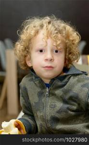 a portrait of young blond curly boy