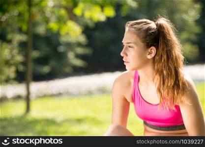 a portrait of young fit woman outdoors