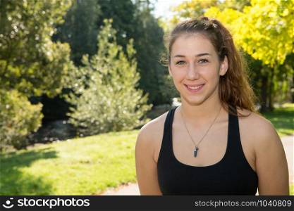 a portrait of young fit woman outdoors