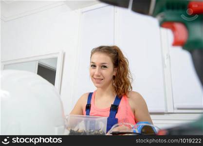 a portrait of young woman apprentice carpenter