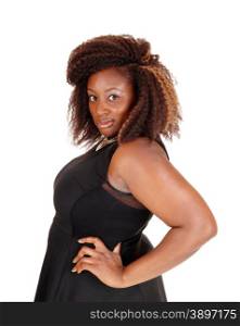 A portrait picture of a African American woman in a black dress with herhands on her hips, isolated for white background.