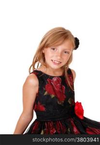 A portrait picture of a blond young girl in a black and red dress sittingisolated for white background.