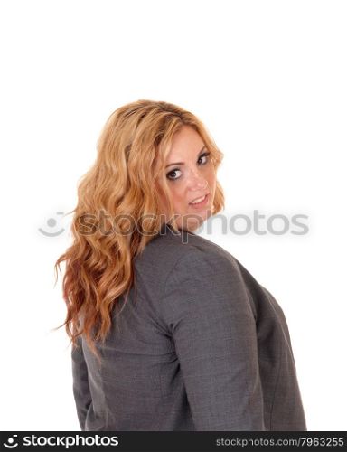 A portrait picture of a plus size blond business woman, looking over her shoulder into the camera, isolated for white background.