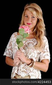 A portrait shot of a gorgeous young woman with long curly blond hair, holding a pink rose, for black background.