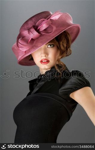 A portraot of a vintage sexy lady wearing black dress and colored hat.