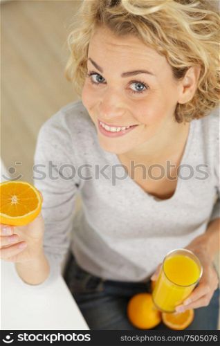 a positive woman holding oranges