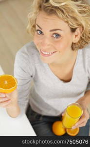 a positive woman holding oranges