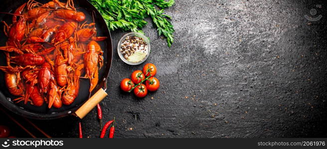 A pot of boiled crayfish and spices. On a black background. High quality photo. A pot of boiled crayfish and spices.