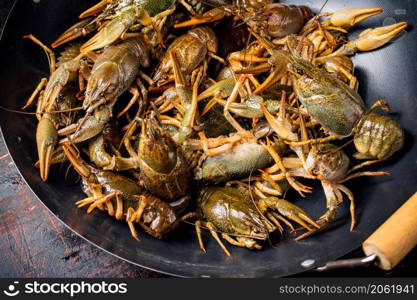 A pot of fresh crayfish. Against a dark background. High quality photo. A pot of fresh crayfish.