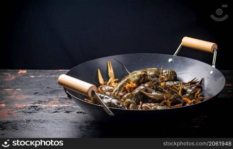 A pot of fresh crayfish. Against a dark background. High quality photo. A pot of fresh crayfish.
