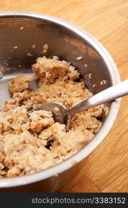 A pot of old cold porridge on a wooden table