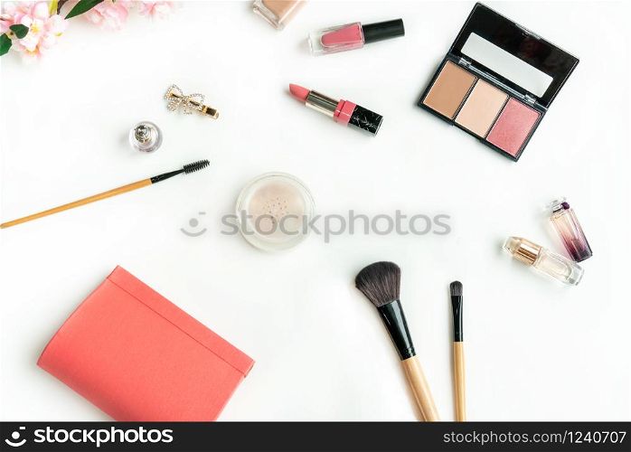 A pouch and various cosmetics and brushes isolated on white background, Top view, Beauty concept