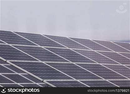 A power plant using renewable solar energy with the sun. Solar cells or photovoltaic cells in solar power plant station turn up skyward absorb the sunlight from the sun. closeup of photo.