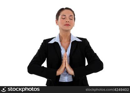 A praying businesswoman.