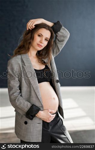 A pregnant girl with a bare big belly.. A photo of a pregnant girl in a photo studio 4116.
