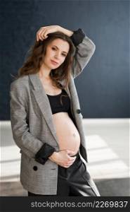 A pregnant girl with a bare big belly.. A photo of a pregnant girl in a photo studio 4116.