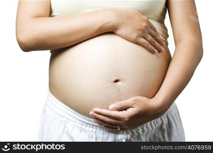 A pregnant woman holding her stomach caressing her unborn child