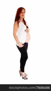 A pregnant woman in a black bra and tights with a white shirt,standing isolated for white background.