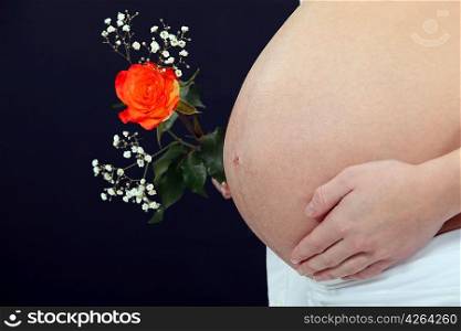 A pregnant woman with a flower.