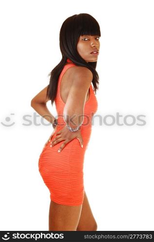 A pretty African America girl in a dress and red heels standing for whitebackground with her long black hair.