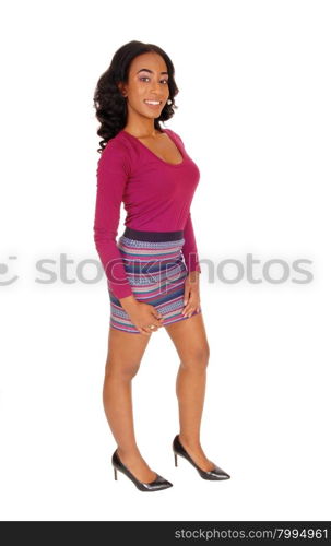 A pretty African American woman in a burgundy sweater and striped skirtstanding in profile, isolated for white background.