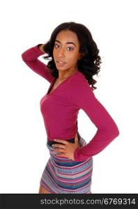 A pretty african american woman in a burgundy sweater and striped skirtwith one hand on her head, standing isolated for white background.