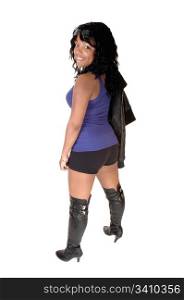 A pretty African American woman in shorts, a leather jacket andboots, standing from the back, for white background.