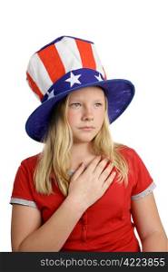 A pretty American girl in a stars and stripes hat, solemnly saying the pledge of allegiance. Isolated on white.