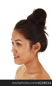 A pretty and skinny Asian woman with her long hair up and free shoulderin profile for white background.
