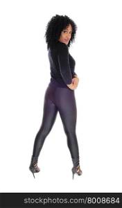 A pretty and slim African American woman in black tights and sweaterstanding from the back, isolated for white background.