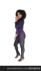 A pretty and slim African American woman in black tights and sweaterstanding in profile isolated for white background.