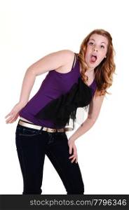 A pretty blond hair young woman in jeans and purple top, screamingin the studio, for white background.