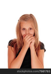 A pretty blond slim girl holding her hands over her mouth, lookingscared, isolated for white background.