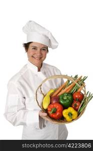 A pretty chef holding a basket of fresh vegetables. Isolated on white.
