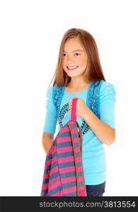 A pretty eight year old girl is looking and holding her backpack in a closeuppicture, isolated on white background.