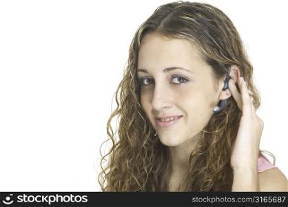 A pretty female talks on a hands-free wireless headset
