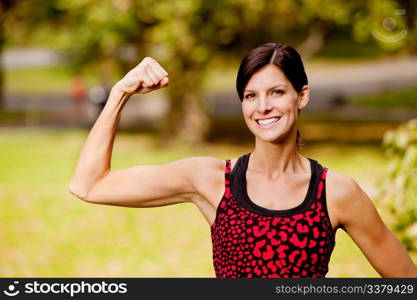 A pretty fitness model flexing her bicep