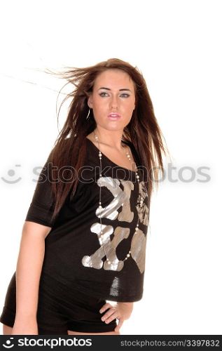 A pretty girl standing in the studio and the wind is blowing into her hair, over white background.
