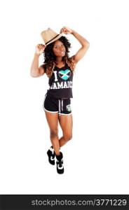 A pretty Jamaican woman in exercise outfit and a cowboy hat on her longblack and brown hair standing isolated for white background.