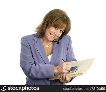 A pretty, mature business woman talking on the cellphone and writing in her pda. Isolated on white.