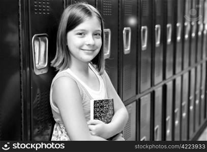 A pretty school girl leaning against her locker. Black and white.