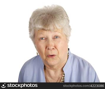 A pretty senior woman looking sad and upset. Isolated on white.