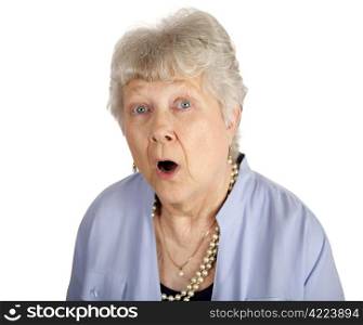 A pretty senior woman with a look of shock on her face. Isolated on white.