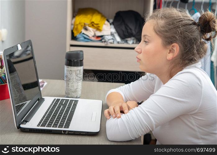 a pretty teenage girl doing homework on the desk