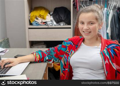 a pretty teenage girl doing homework on the desk