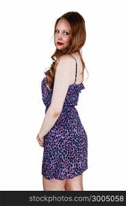 A pretty teenage girl in a blue dress with long brunette hair standingisolated for white background.