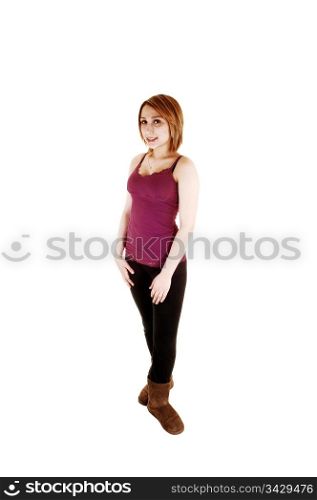 A pretty teenage girl in black tights and brown boots standing from thefront in the studio, for white background.
