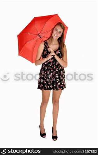 A pretty teenager in a black collared dress and heels whit a red umbrellastanding in the studio for white background.