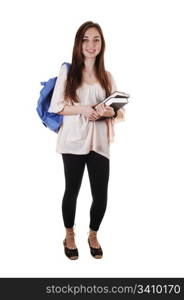 A pretty teenager in black tights and a blue backpack over her shoulderand books in her hand, standing in the studio for white background.